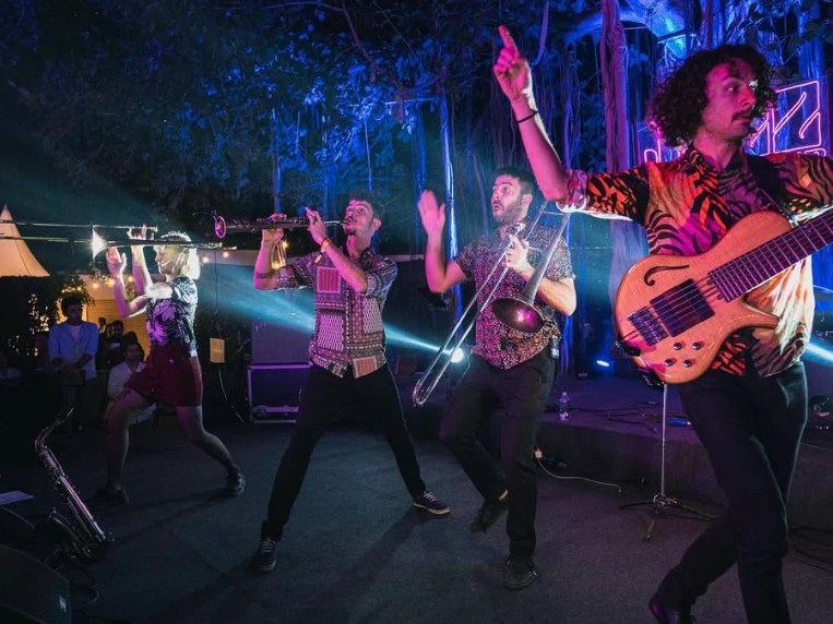 Desmadre XL spielt nachts unter freiem Himmel, mit Trompete, Posaune und Bass
